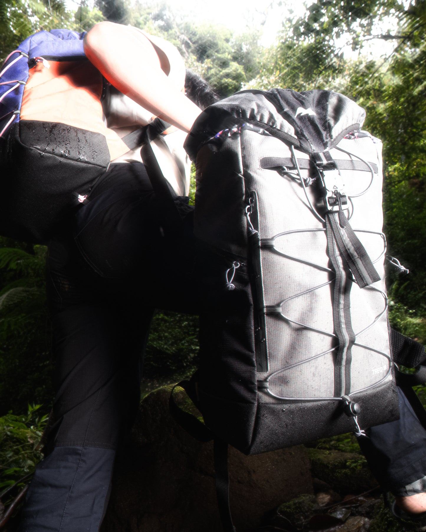 A user climbing with the TREQ WILDFLARE Trail 22L Outdoor Backpack, demonstrating its suitability for rugged outdoor environments.