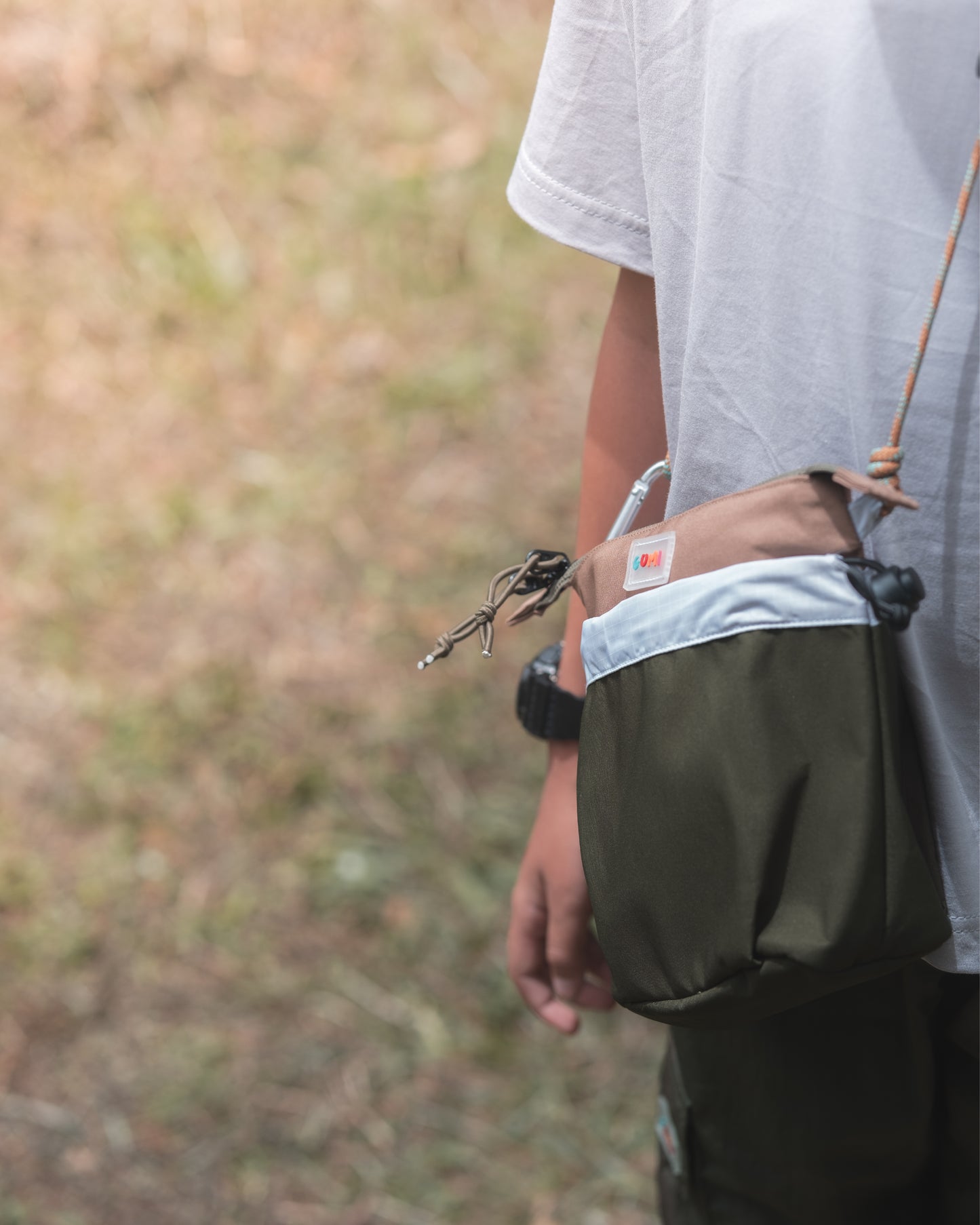 Detailed view of the PIXIES Nutty Sprout bag on a child's side, showing its convenient and compact features for little explorers.
