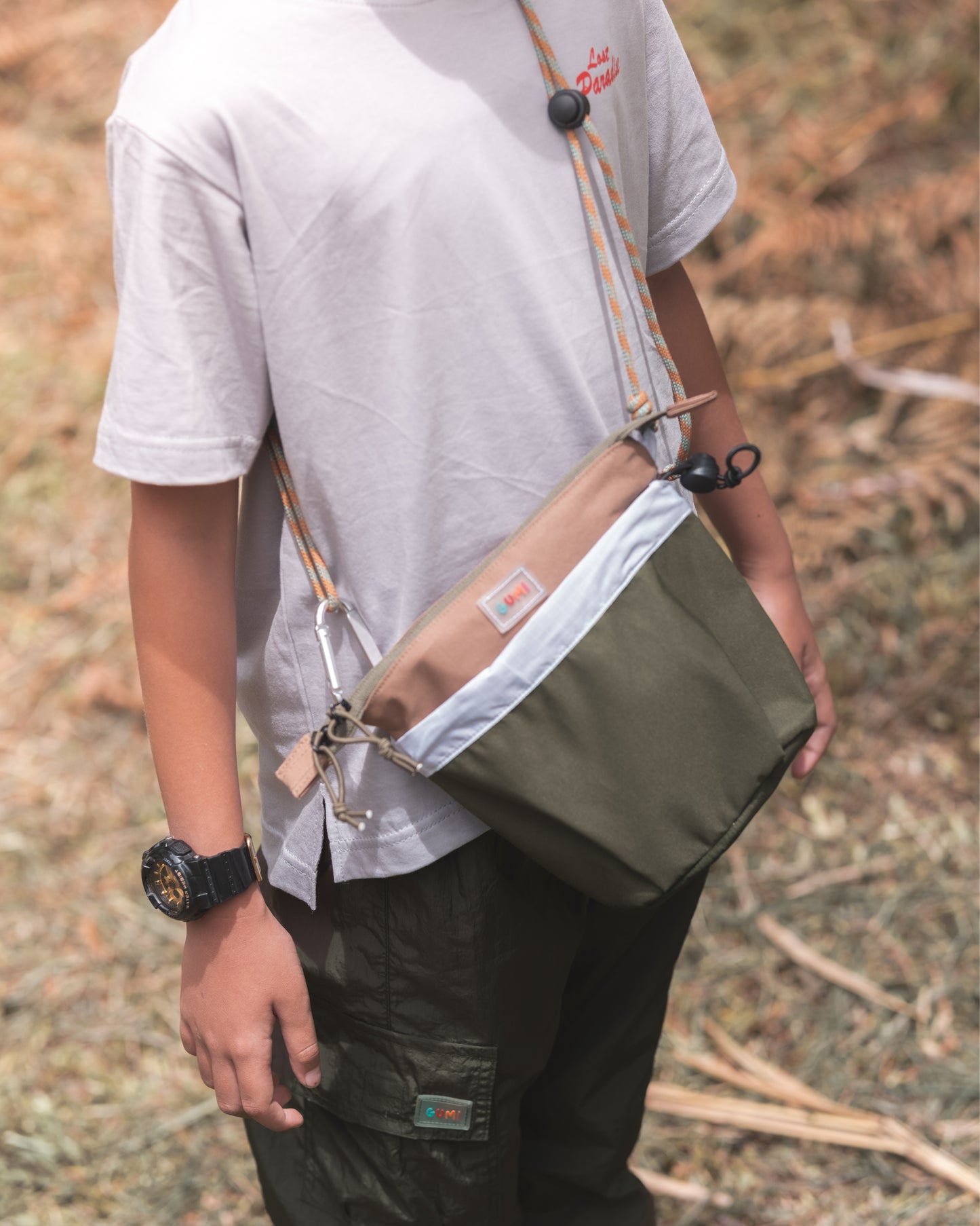 Close-up of a child wearing the PIXIES Nutty Sprout bag, highlighting its adjustable strap and stylish design.
