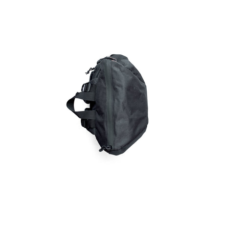 TREQ SHADOW Trail 22L Outdoor Backpack viewed from the side, showcasing its compact build and side zip pockets.